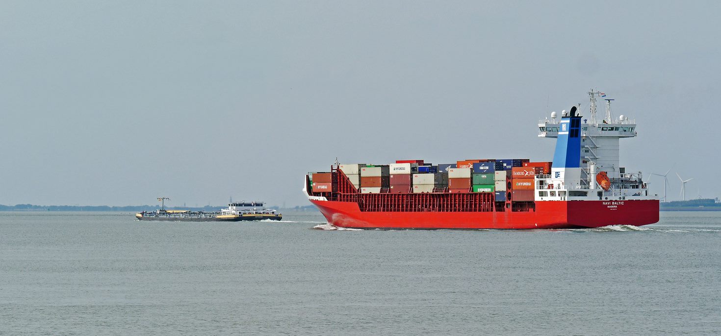 Cargo maritime ship carrying multicoloured cargo containers.